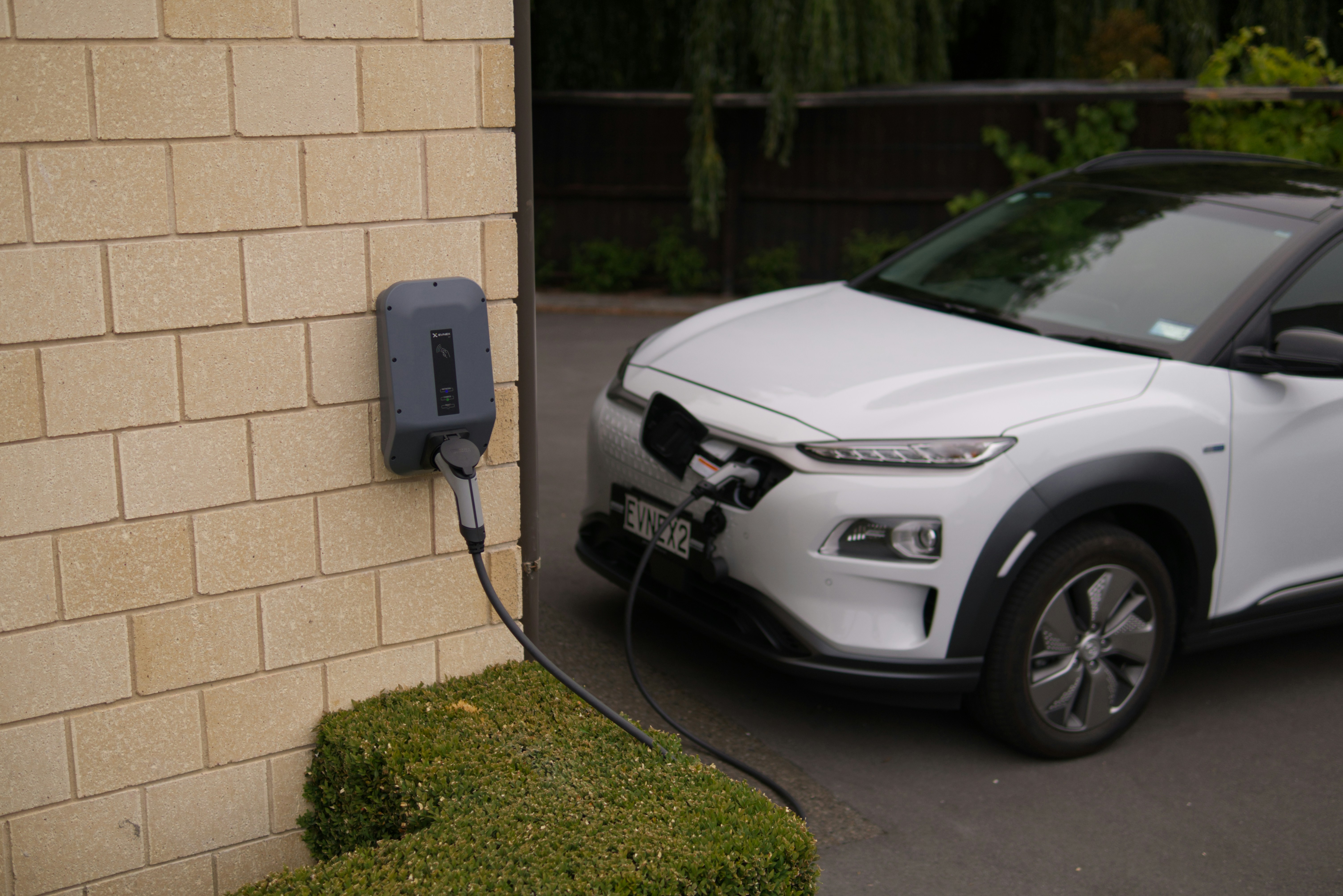Wall-mounted EV charging point on a residential driveway
